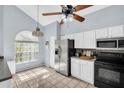 Bright kitchen featuring modern appliances, white cabinets, and an eat-in area at 1715 Larabie Ct, Brandon, FL 33511