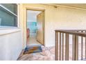 Condo entrance with a 'Welcome' mat leading to a glimpse of the unit's beach-themed decor at 18610 Gulf Blvd # 607, Indian Shores, FL 33785