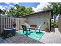 Outdoor patio with furniture, decorative rug, privacy fence, and storage shed, great for relaxing at 1933 Whitney Way, Clearwater, FL 33760