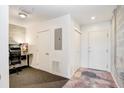 Small office with a desk and chair adjacent to a storage area with white doors at 2001 E 2Nd Ave # 37, Tampa, FL 33605