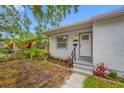 This charming home features a stucco exterior, manicured landscaping, and a welcoming entryway, perfect for curb appeal at 2326 Auburn S St, St Petersburg, FL 33712