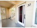 Inviting condo entryway featuring a decorative door, modern security, and a glimpse of the building's unique architectural details at 2330 Ecuadorian Way # 30, Clearwater, FL 33763