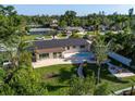 Aerial view of a home with a swimming pool, patio, and tropical landscaping in a residential neighborhood at 243 45Th Ne Ave, St Petersburg, FL 33703