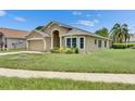 Attractive single-story home with a well-kept lawn and beautiful landscaping at 25327 Seven Rivers Cir, Land O Lakes, FL 34639