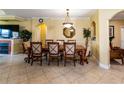 Formal dining room featuring a wooden table with seating for eight, decorative mirror and chandelier at 2724 Via Murano # 639, Clearwater, FL 33764
