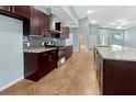Modern kitchen with dark cabinets, granite countertops, and stainless steel appliances at 2950 N North Oriente Avenue N Ave, Sarasota, FL 34235