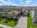 Stunning home features a three-car garage, lush landscaping, and a beautiful paver driveway at 3326 Acacia Bay Ave, Wesley Chapel, FL 33543