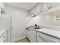 Efficient kitchen with white appliances, ample cabinet space, and view to the entry hallway and living space at 36750 Us 19 N # 20311, Palm Harbor, FL 34684