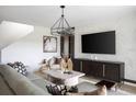 Inviting living room with modern decor, a large TV, and comfortable seating at 36927 Sagemoor Dr, Zephyrhills, FL 33541