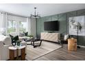 Inviting living room with stylish decor, large windows offering ample natural light, and a cozy ambiance for relaxation and entertainment at 37225 Sagemoor Dr, Zephyrhills, FL 33541