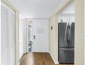 Inviting entryway featuring a white door with glass panel and hardwood flooring at 4202 Harbor House Dr # 24, Tampa, FL 33615