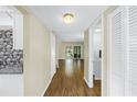 Open-concept living room with hardwood flooring, neutral walls, and sliding doors to the lanai at 4202 Harbor House Dr # 24, Tampa, FL 33615