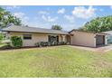 Charming single-story home featuring a well-maintained lawn, mature landscaping, and a brick-lined walkway at 4228 Belle Isle Ct, New Port Richey, FL 34653