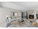 Cozy living room with neutral furniture, tile floors, and a fireplace at 4777 Duhme Rd # 1D, St Petersburg, FL 33708