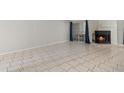 Spacious living area featuring tile flooring and a view of the fireplace at 4777 Duhme Rd # 1D, St Petersburg, FL 33708