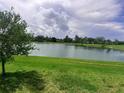 Scenic view of the lake and lush green landscaping at 5082 Inshore Landings Dr, Apollo Beach, FL 33572
