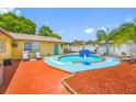 Backyard oasis featuring a sparkling pool with a basketball hoop, lounge chairs, and patio area at 5236 Madison St, New Port Richey, FL 34652