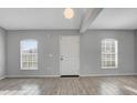 Bright living room featuring wood floors, large windows, and a welcoming entrance at 5396 Berrien Ave, Spring Hill, FL 34608