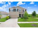 Charming two-story home featuring a well-manicured lawn, inviting entrance, and attached two car garage at 5430 Thistle Field Ct, Wesley Chapel, FL 33545