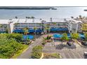 Condo exterior featuring covered parking, lush landscaping and well-maintained grounds at 615 Dream Island Pl # 210, Longboat Key, FL 34228
