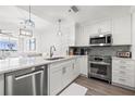 Modern kitchen features stainless steel appliances, white cabinets, and an open layout at 615 Dream Island Pl # 210, Longboat Key, FL 34228