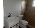 Bathroom featuring a new vanity, modern toilet, and tiled shower at 8033 55Th E St, Palmetto, FL 34221