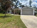 Front exterior of a well-kept single-Gathering home with a two-car garage at 8033 55Th E St, Palmetto, FL 34221