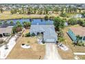Aerial view of a well-maintained home with a backyard pond and proximity to a community park at 832 Birdie Way, Apollo Beach, FL 33572