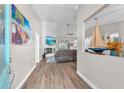 Inviting entryway showcasing hardwood floors, a view of the living area, and stylish decor at 832 Birdie Way, Apollo Beach, FL 33572
