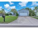 Charming single Gathering home boasting a well maintained lawn, two car garage, and welcoming curb appeal at 832 Birdie Way, Apollo Beach, FL 33572