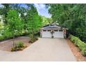 Charming home with a two-car garage, brick-lined driveway, and well-manicured landscaping at 8903 Donna Lu Dr, Odessa, FL 33556