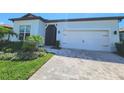 A lovely home with a charming walkway and a well-manicured lawn at 9024 Barrier Coast Trl, Parrish, FL 34219