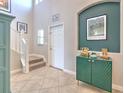 Welcoming foyer with tile flooring, staircase, and stylish decor at 10081 Sage Creek Dr, Sun City Center, FL 33573