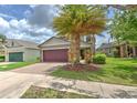 Well-maintained home with a brick driveway, two-car garage, and mature landscaping at 10081 Sage Creek Dr, Sun City Center, FL 33573