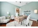 Home office space with stylish desk, comfortable seating, and natural light from the French doors at 10513 Palm Cove Ave, Tampa, FL 33647