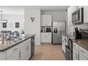 Modern kitchen with stainless steel appliances, granite countertops, and white cabinets at 10823 Trailing Vine Dr, Tampa, FL 33610