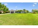 Landscaped home with well-manicured lawn, palms and a brick driveway at 1432 50Th Ne Ave, St Petersburg, FL 33703