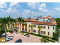 Aerial view of the building with palm trees, red brick parking lot, and downtown skyline at 1501 W Horatio St # 101, Tampa, FL 33606
