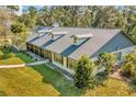 Charming single-story home with dormer windows, grey roof and lush green lawn at 15234 Scanio Dr, Spring Hill, FL 34610
