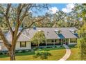 Beautiful single-story home featuring a screened-in porch and a well-manicured lawn at 15234 Scanio Dr, Spring Hill, FL 34610