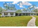 Inviting single-story home with well-maintained lawn and screened porch at 15234 Scanio Dr, Spring Hill, FL 34610
