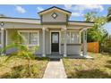 Close-up of the front door showcasing its unique design, gray paint, and well-manicured landscaping at 1905 E Broad St, Tampa, FL 33610