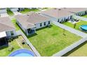 Aerial view of a spacious backyard with a white fence, pool, and plenty of green space for outdoor activities at 191 Brofield St, Brooksville, FL 34604