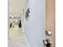 Inviting hallway featuring sleek tile flooring and modern decor leading to a bright living space at 2003 Greenbriar Blvd # 8, Clearwater, FL 33763