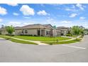 Corner lot home with lush green lawns, mature trees, and a three-car garage at 20108 Stone Pine Cir, Lutz, FL 33558