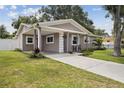 Inviting one-story home featuring a covered entrance and a well-manicured lawn at 2044 Balfour Cir, Tampa, FL 33619