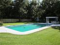 Backyard featuring a sparkling pool with a large deck perfect for entertaining and relaxation at 2143 Wrens Way, Clearwater, FL 33764