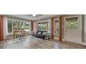 Sun-drenched living room with expansive windows, comfortable seating, and wood-look flooring at 2316 Lancaster Dr, Clearwater, FL 33764