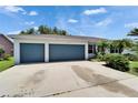 Three-car garage with ample parking space and well-maintained driveway at 2719 Wilder Trace Ct, Plant City, FL 33566