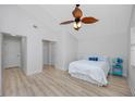 Bright bedroom featuring light wood floors, ceiling fan, and coastal decor at 350 Kentucky Ave, Crystal Beach, FL 34681
